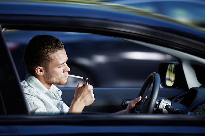 man smoking and driving