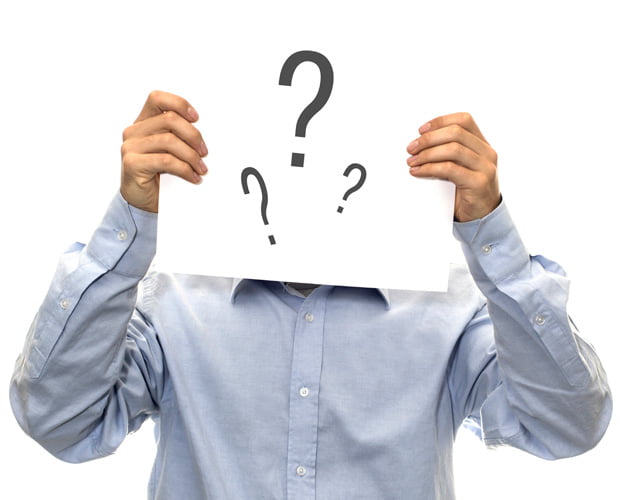 man holding question mark infront of face
