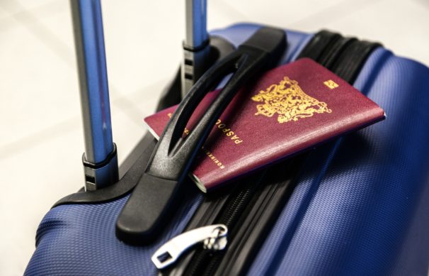 passport ontop of suitcase