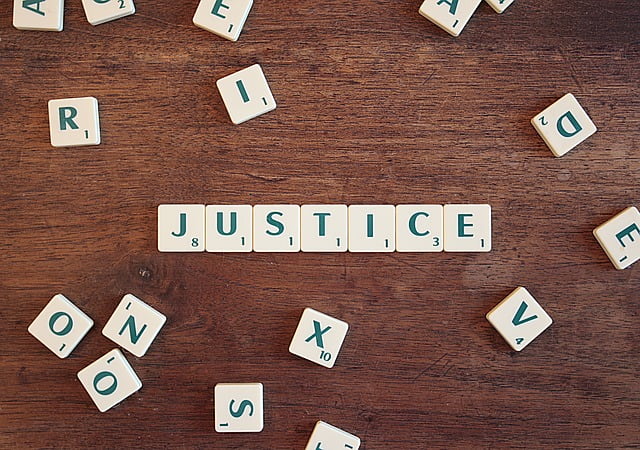 Justice being spelt out with scrabble tiles