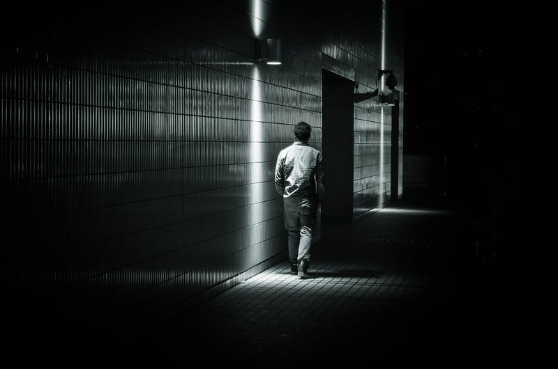 man walking in the dark