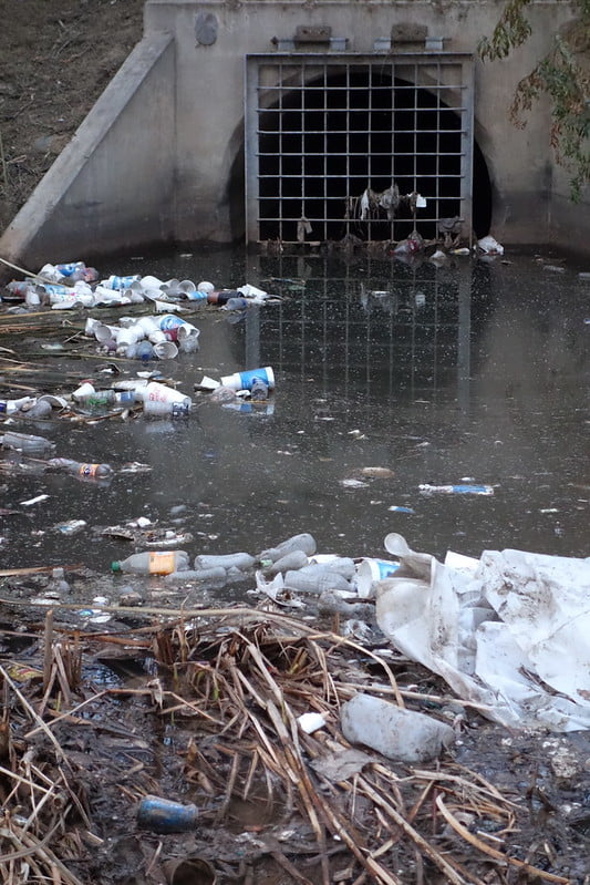 rubbish polluting a water system