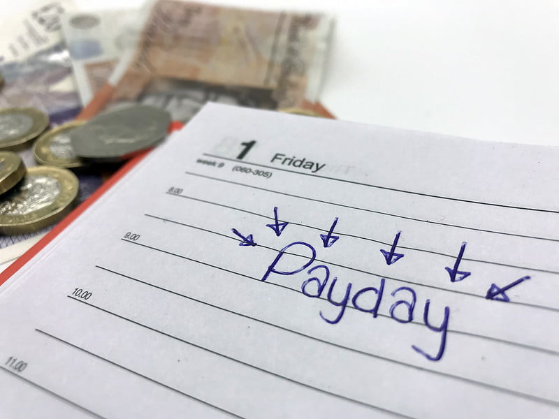 the word payday writen on paper with arrows pointing to it